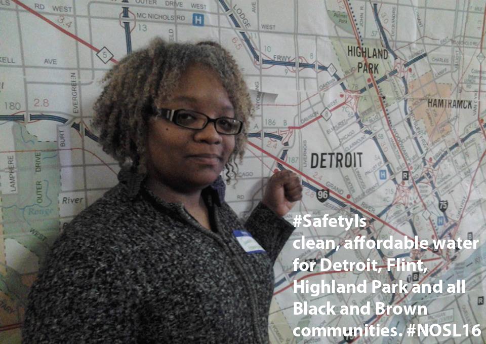 Tawana Petty in front of a map of Detroit with text overlaid saying "SafetyIs clean, affordable water for Detroit, Flint, Highland Park and all Black and Brown communities. #NOSL16"
