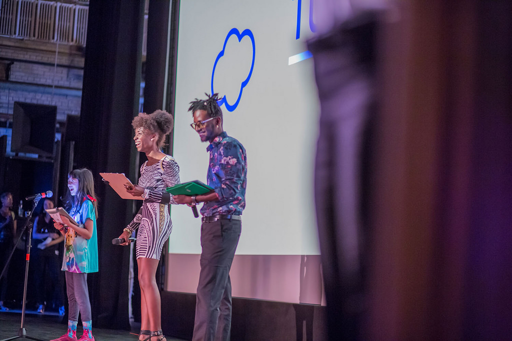 Two adults and a child on the auditorium stage at the AMC