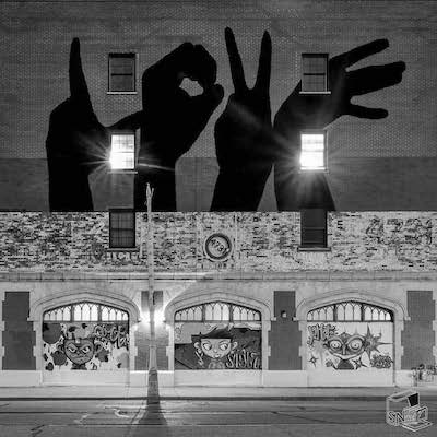 Love building with mural of hands spelling out LOVE in sign language.