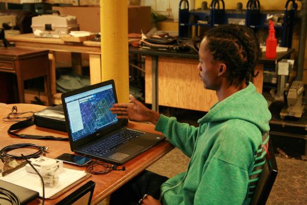 EII Digital Steward working on a map on a laptop