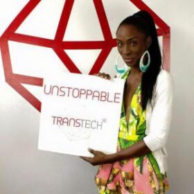 Person holding a sign that says "unstoppable, transtech"