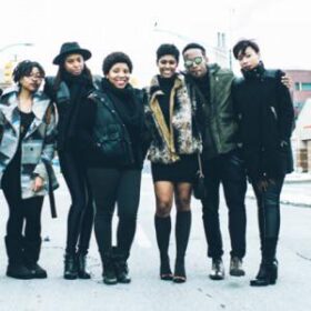 Black Bottom Archives members standing on a sidewalk with arms around each other