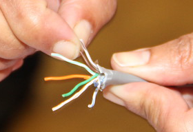 Someone splitting an ethernet cable